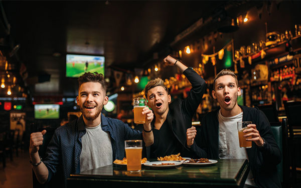 men with beer watch sport