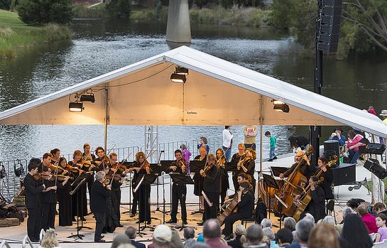 the Canberra Symphony Orchestra plays under a marquee for music by the river