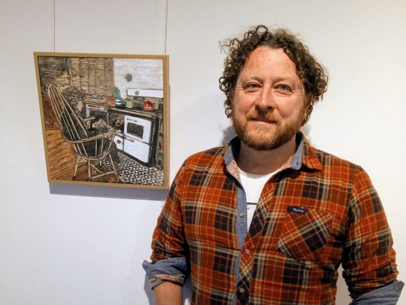 Julian Laffan with one of his framed and painted woodcuts