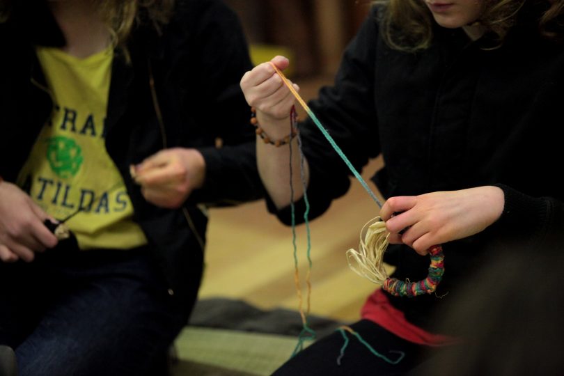 Visitors to the 2018 event practising their weaving technique