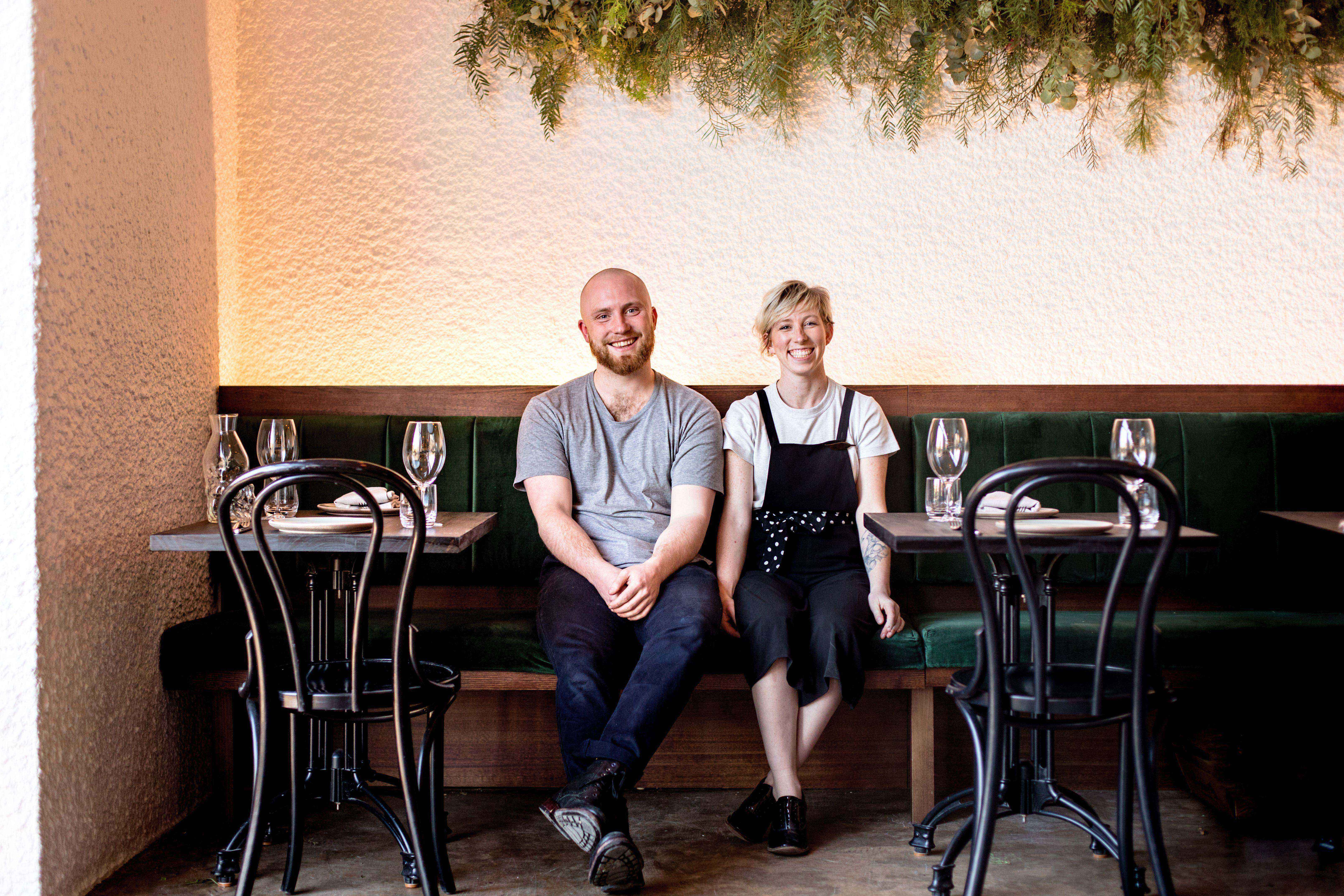 Two people sit in a restaurant.