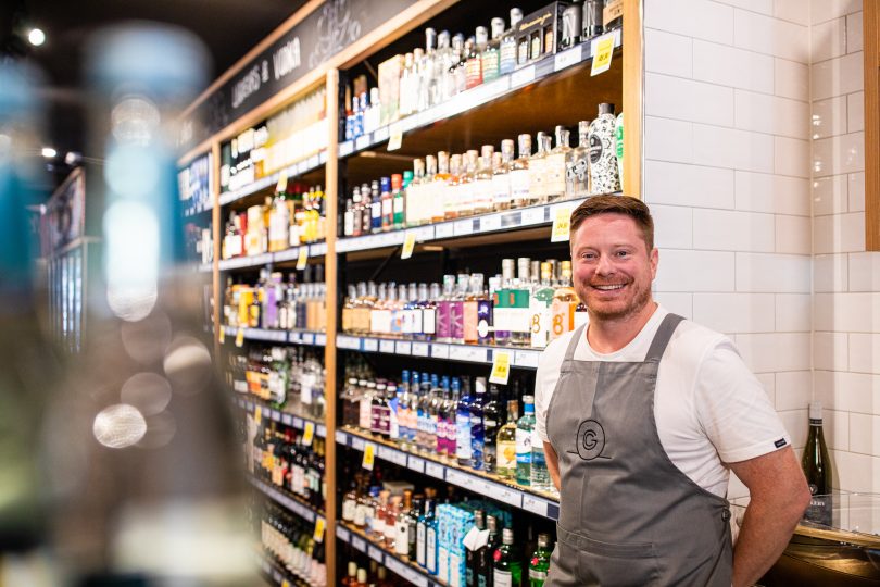 A man stands in a bottle shop