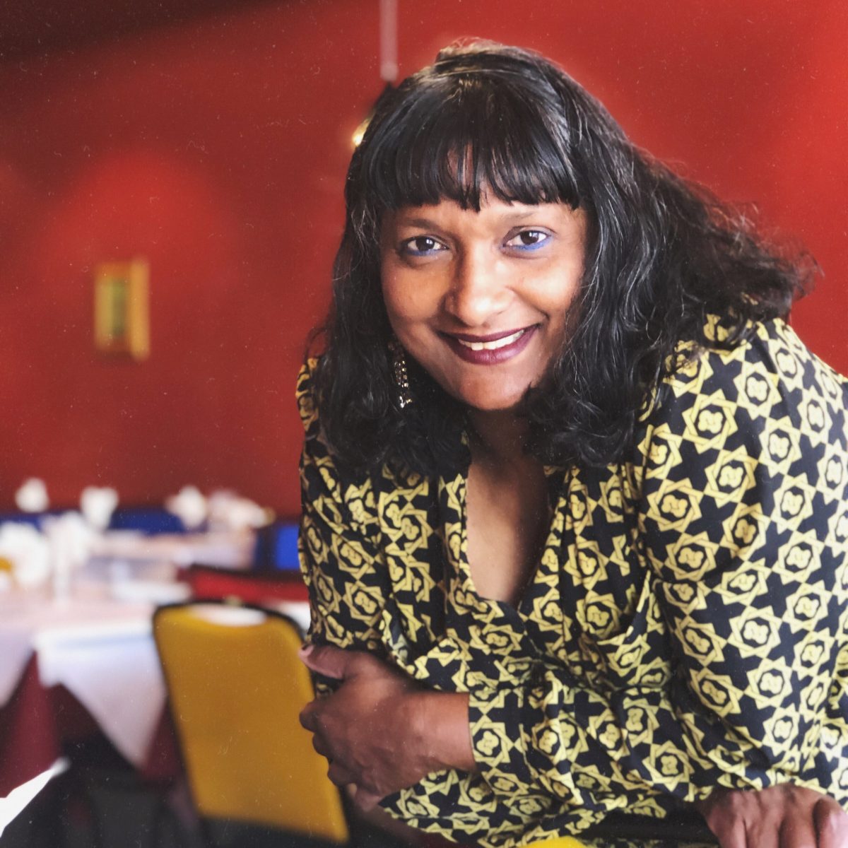 smiling woman in her restaurant