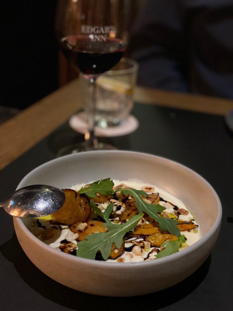 Stracciatella with grilled persimmon and hazelnu