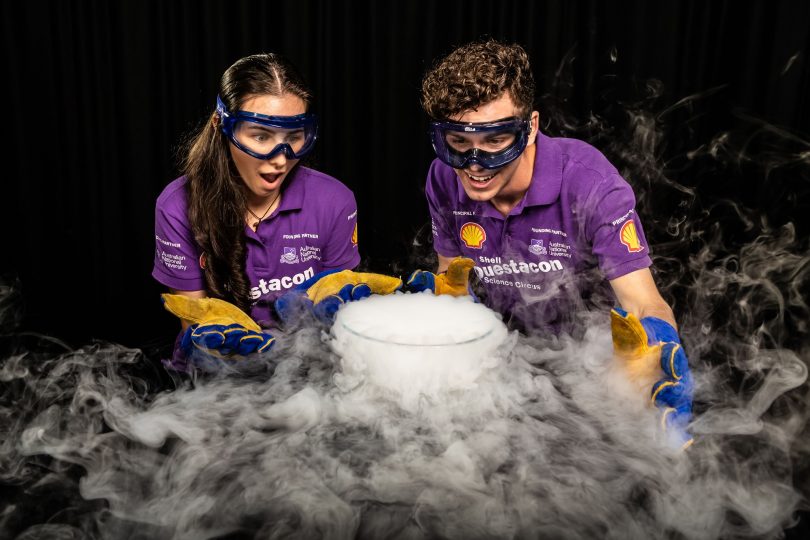 two people with a bowl of liquid nitrogen bubbling over