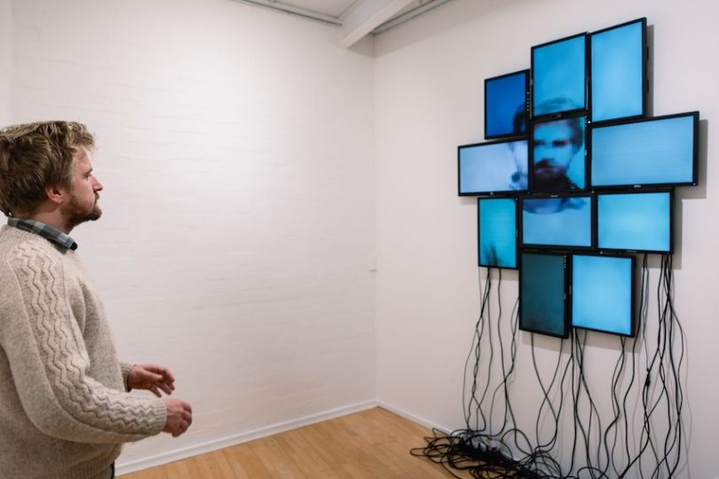Man looking at 'Split' installation at PhotoAccess