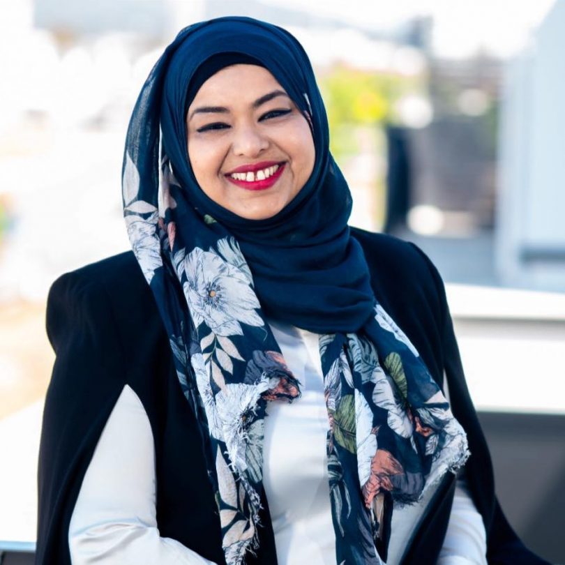 Headshot of smiling woman in hijab