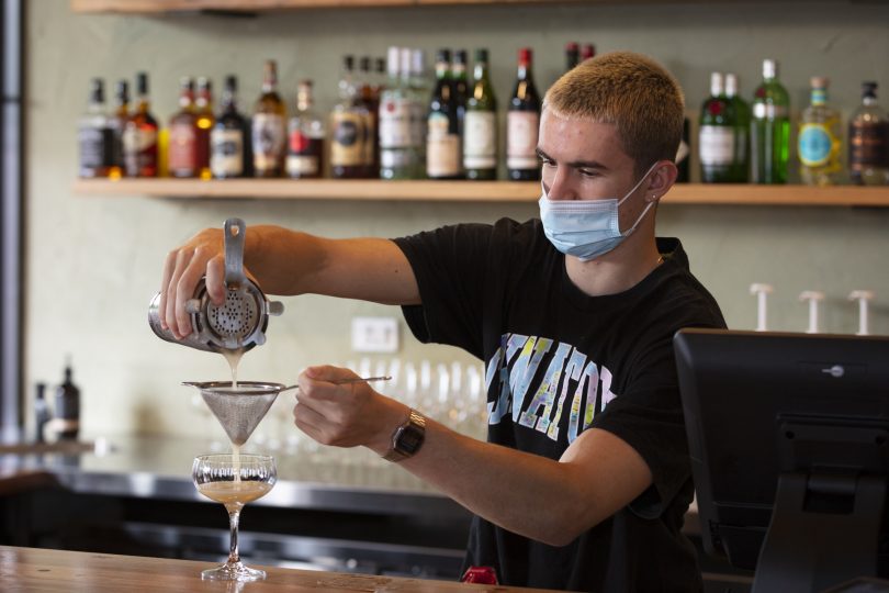 barman pouring cocktail