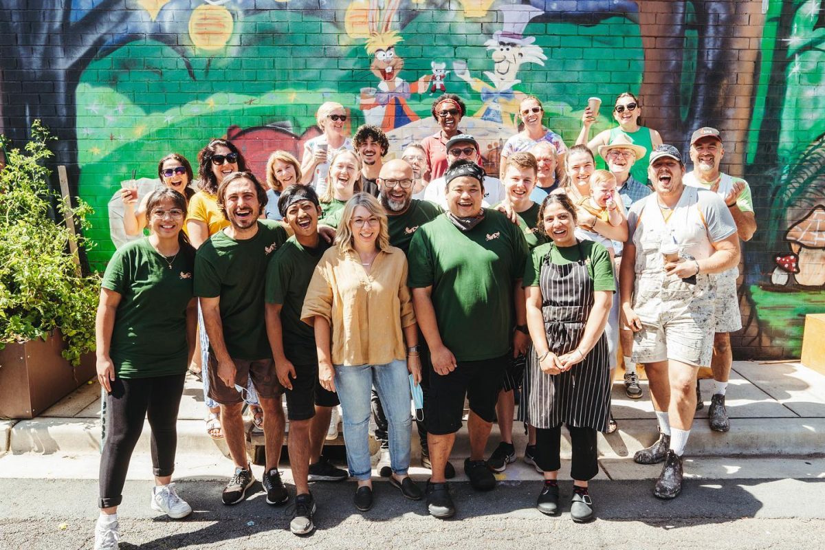 Group photo in front of mural