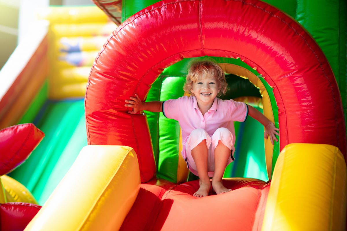 Child in colourful inflatable castle