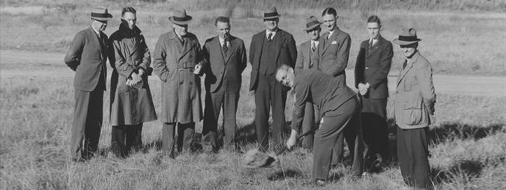 Old photo of men standing in a field