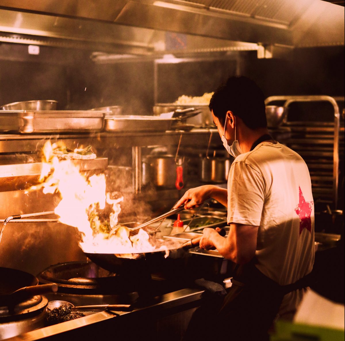 Chef with flaming wok
