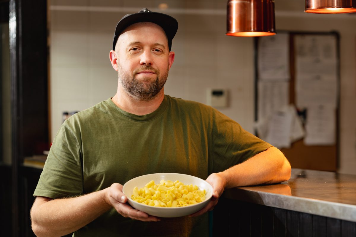Man holding bowl of pasta