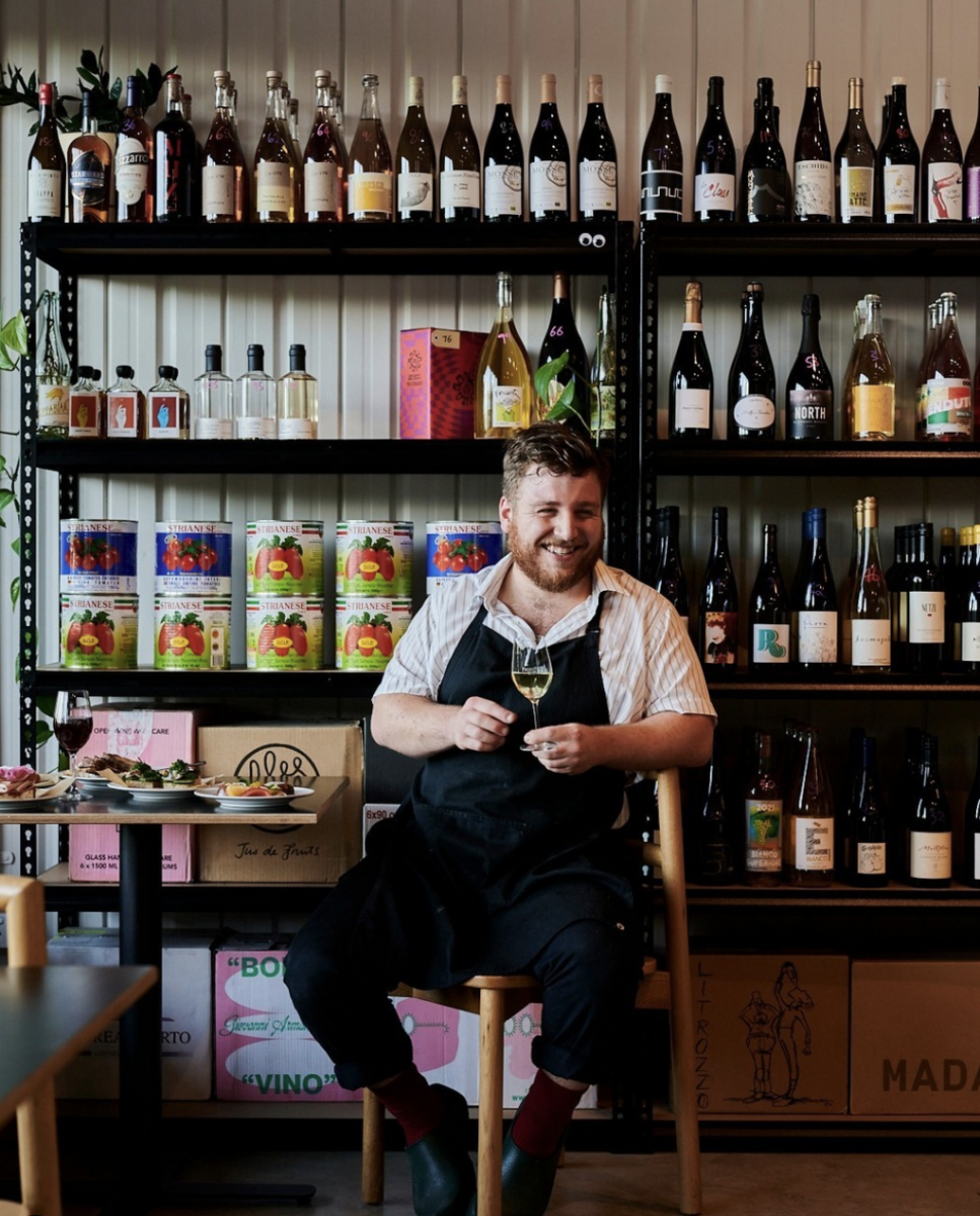 chef in front of wine bottles