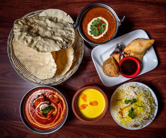 six dishes of colourful indian food