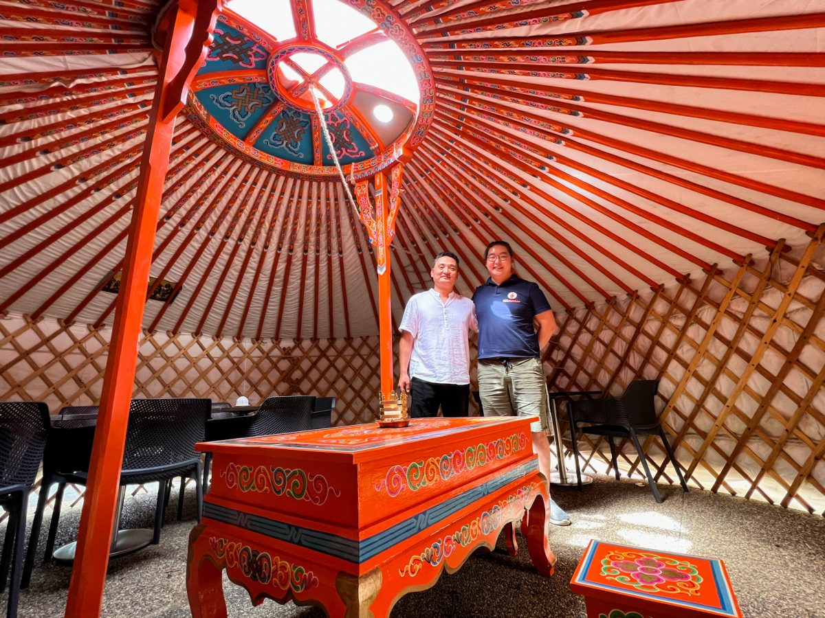 Two men standing in a Mongolian yurt