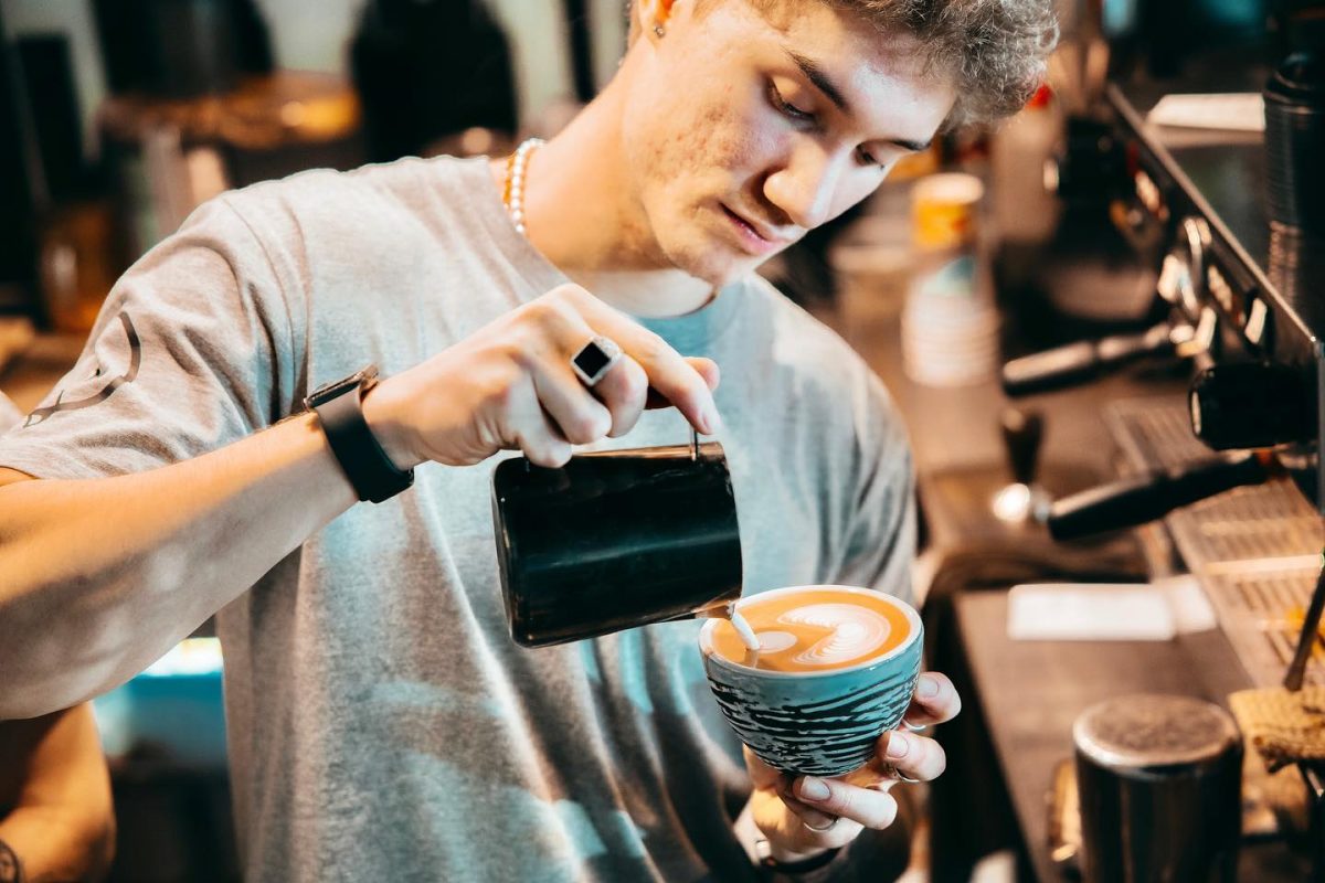 Barista Zac Young pours coffee at Kita