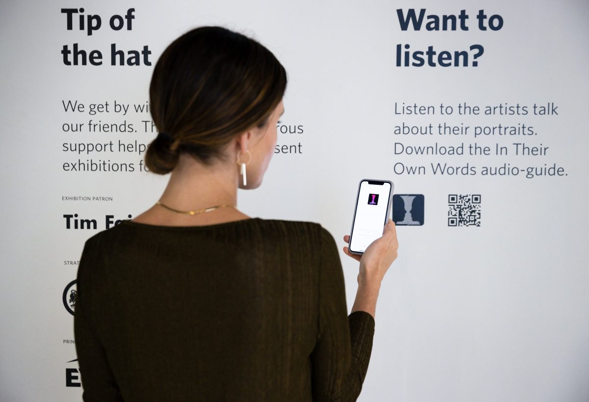 Woman downloads the In Their Own Words app at the National Portrait Gallery in Canberra
