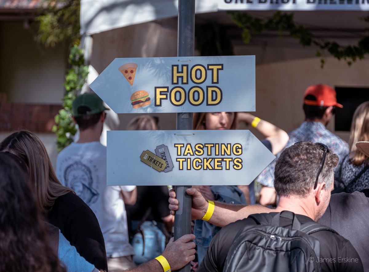 Sign pointing to hot food and tasting tickets