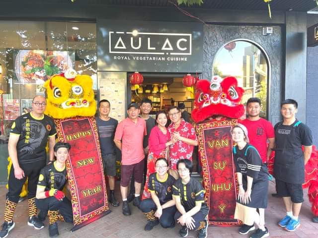 Au Lac Dickson Vegan Cuisine shop-front featuring staff members.
