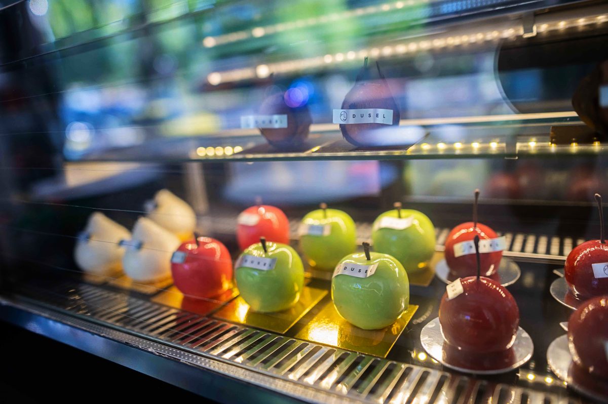 desserts in the shape of green and red apples in a cabinet