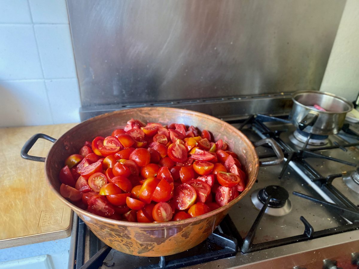 a pot of tomatoes on the stove