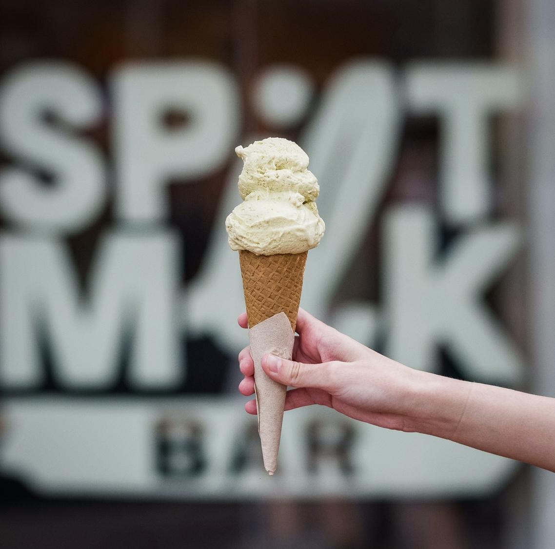 Ice cream cone in front of Spilt Milk sign
