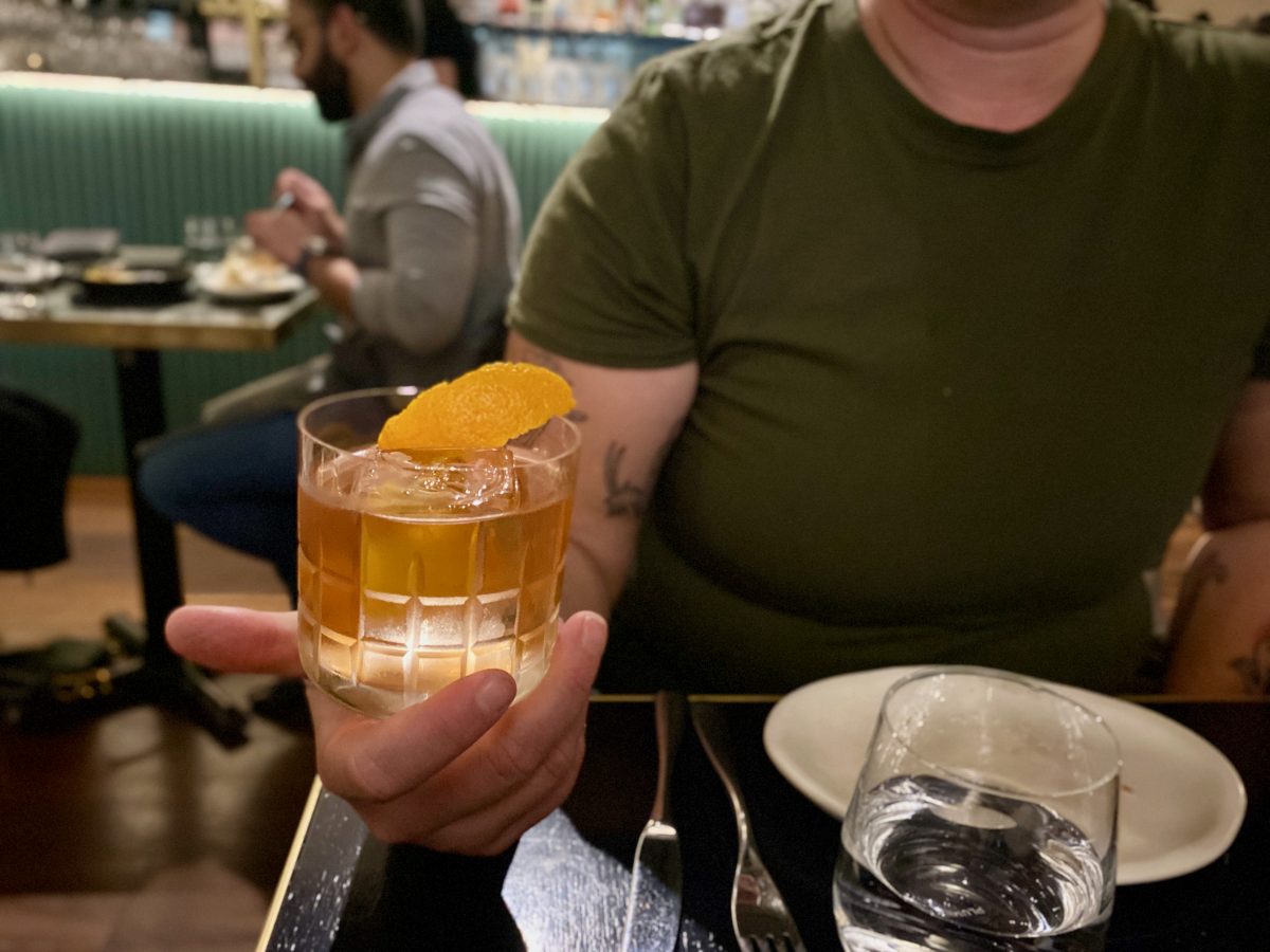 Cocktail with orange twist in tumbler