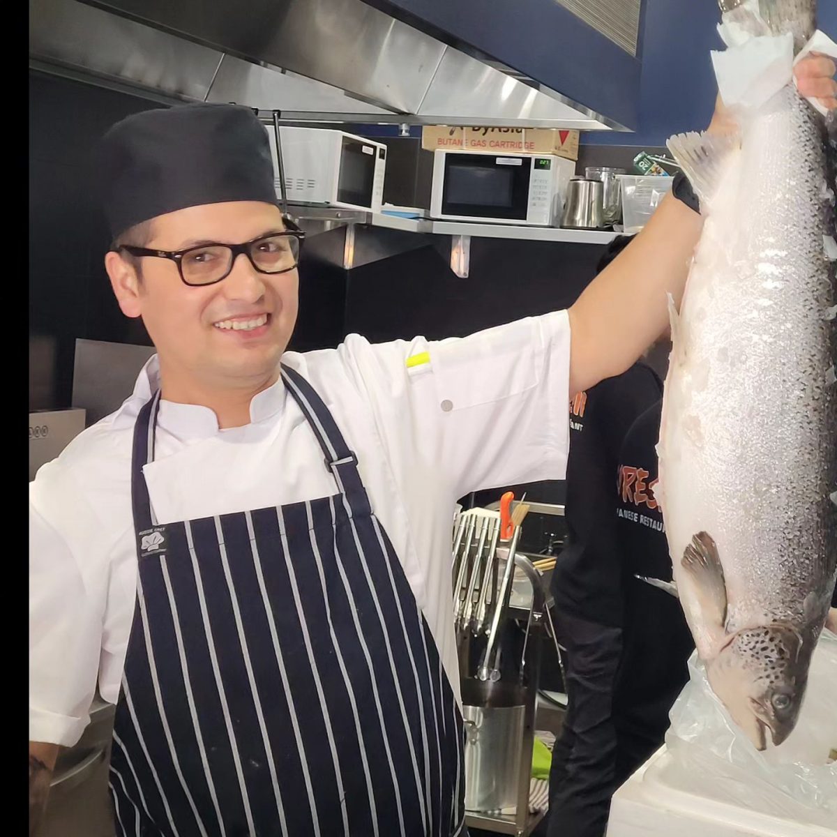 Chef holds a fish