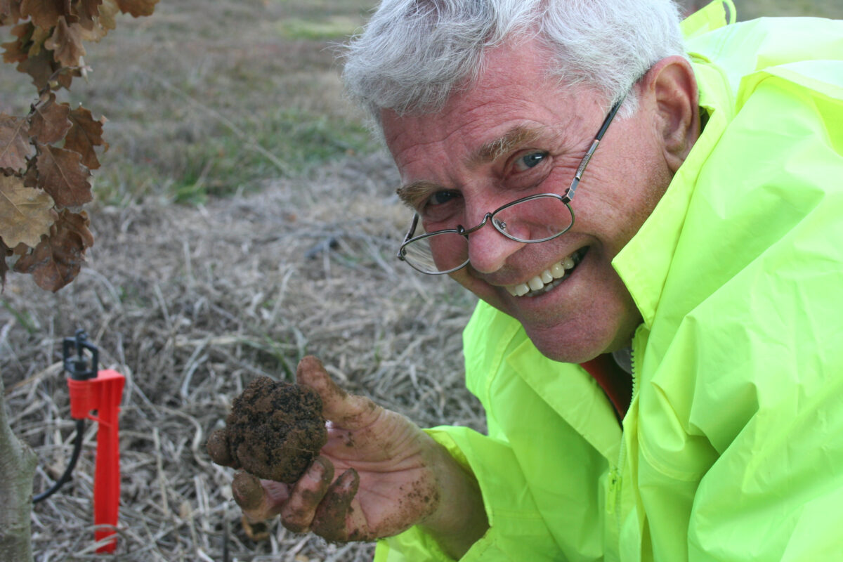 Wayne wearing high vis and holding a truffle