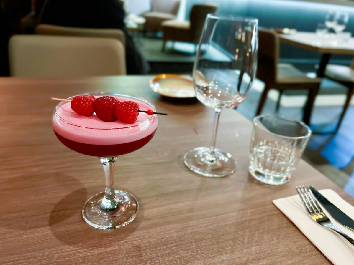 Pink clover club cocktail with raspberries