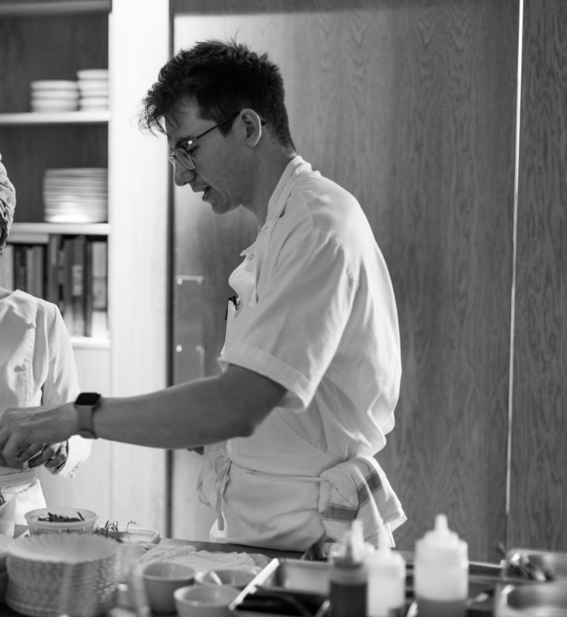 Black and white photo of chef Reece Inkpen in kitchen