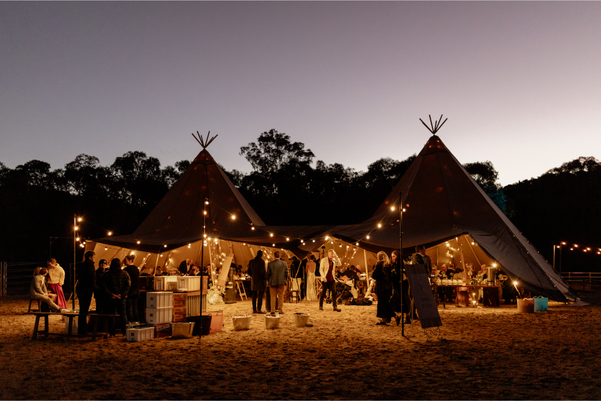 event under tipis with fairy lights
