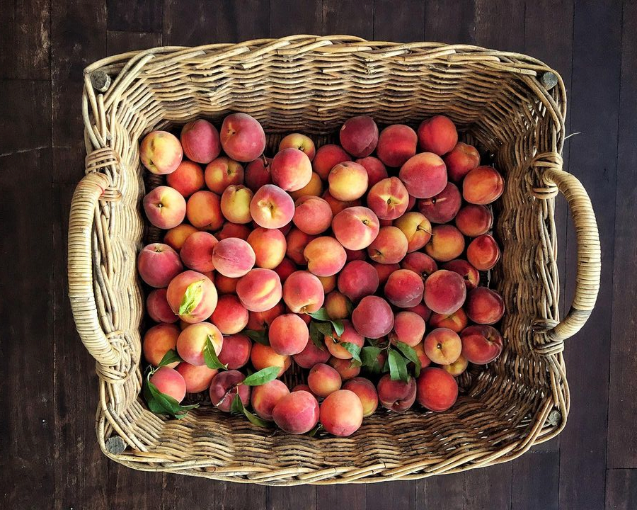 wicker tray of beautiful peaches