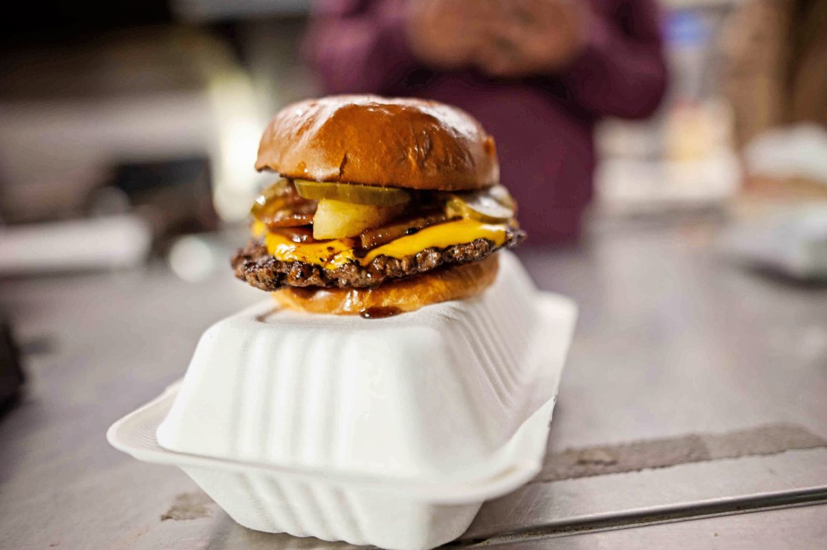A full burger on a takeaway box