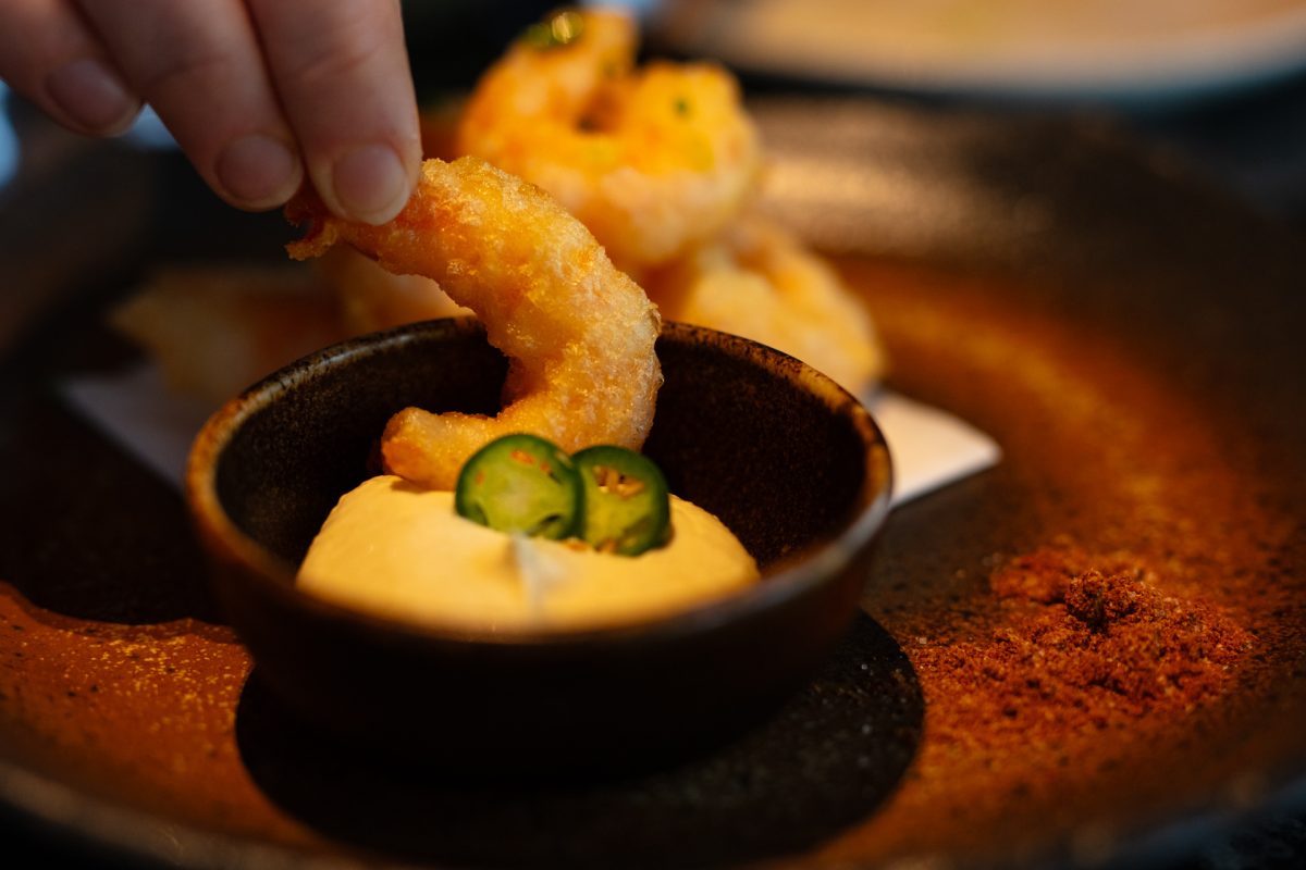 tempura prawn being dipped in mayonnaise