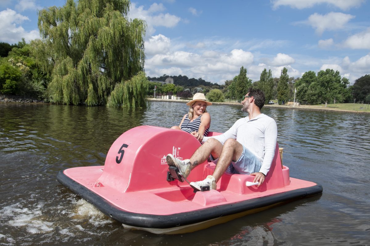 two people on a pink paddleboat