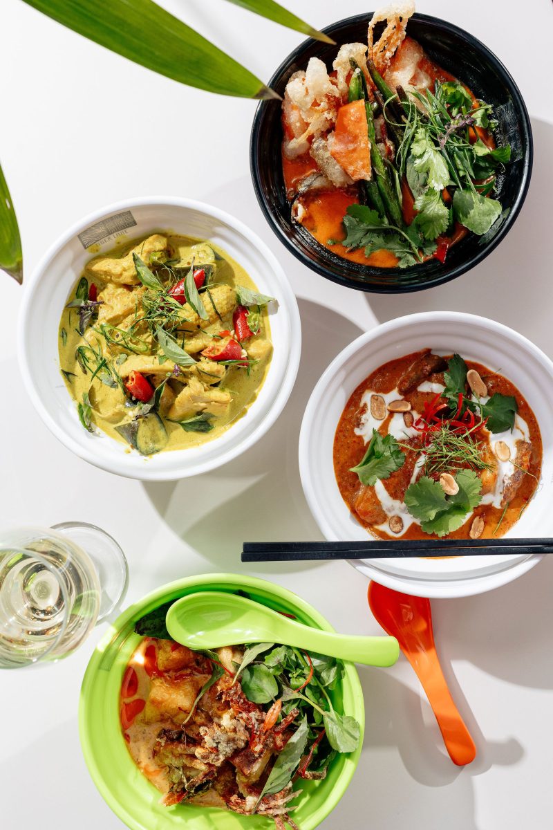 Aerial shot of four colourful bowls of curry.