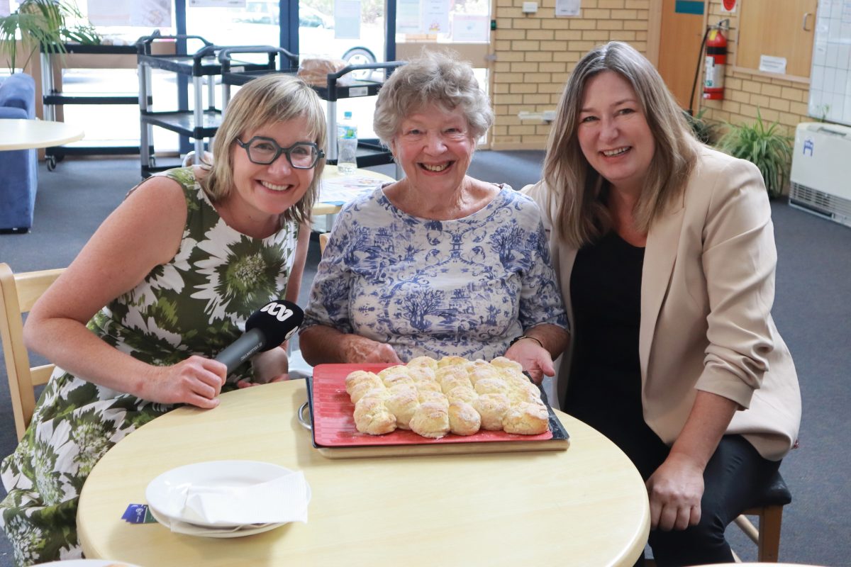 plate of scones in front of three women