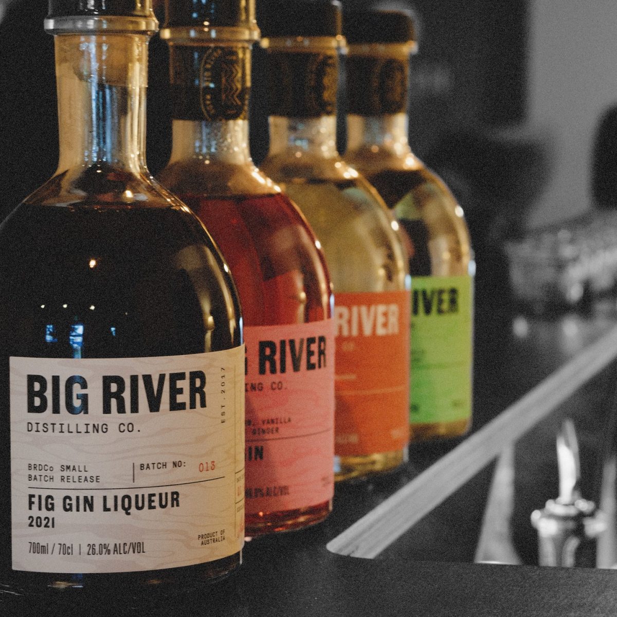 Four colourful bottles of spirits with Big River branding.