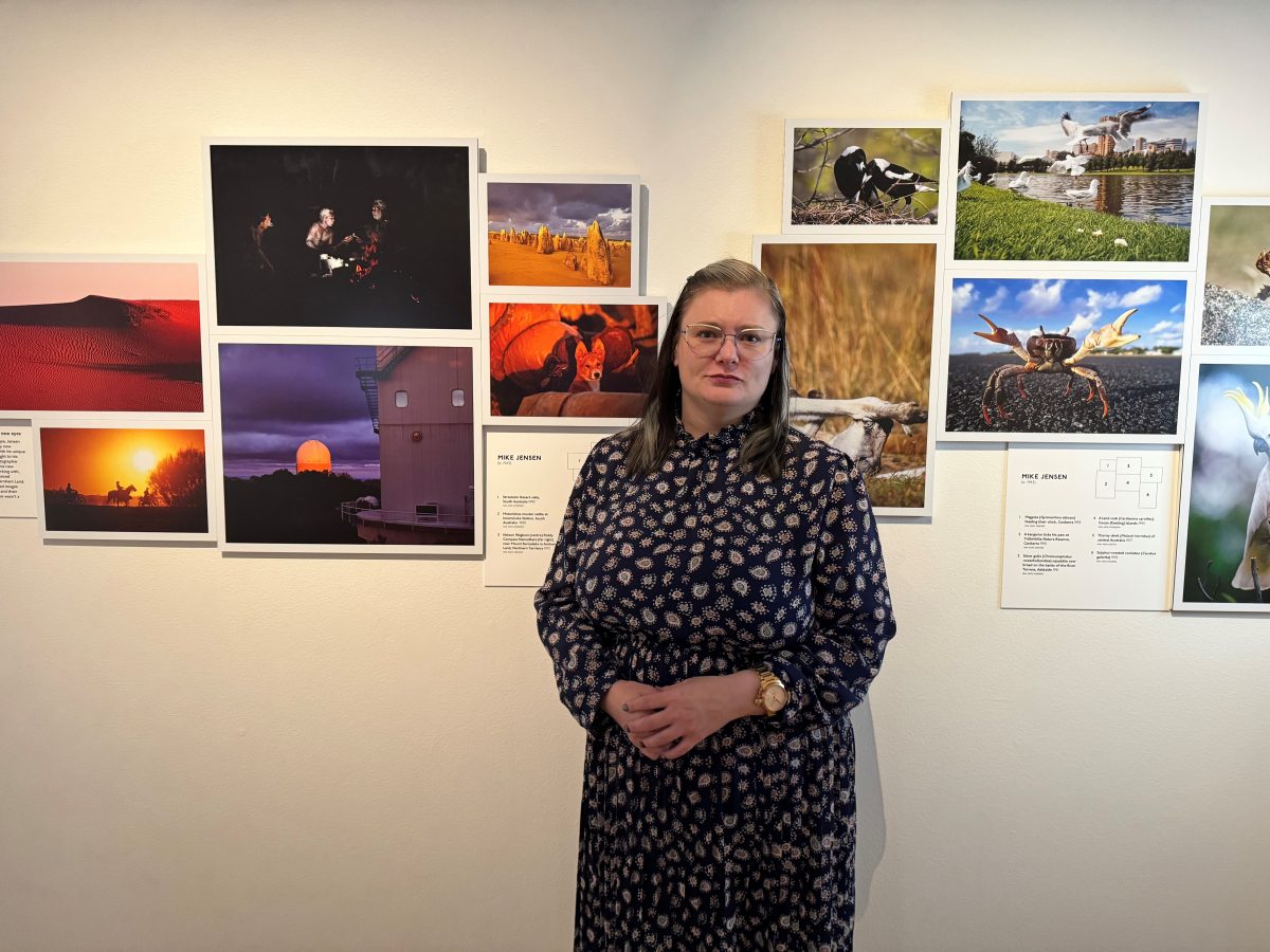 Woman in front of wall of photos