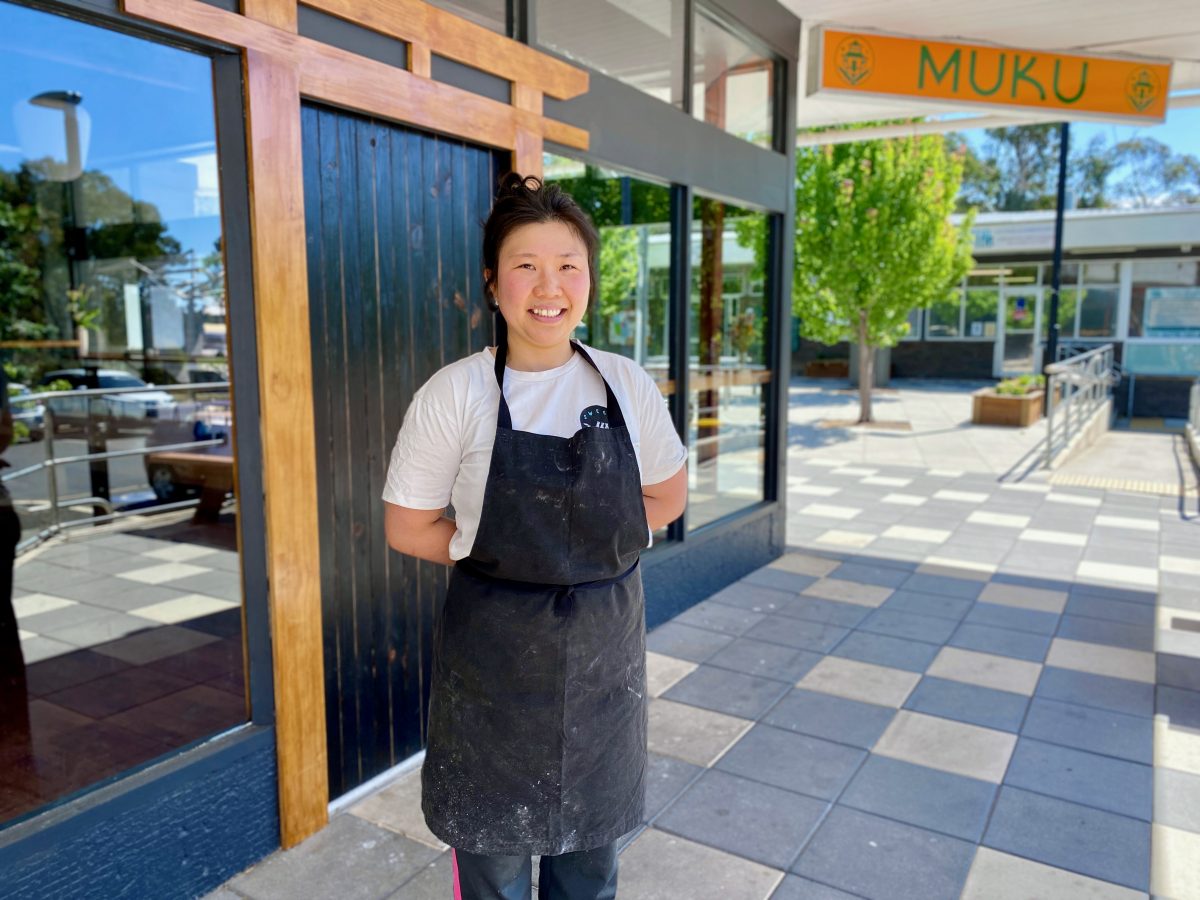 Chef Rina Miyata wearing an apron outside Muku.
