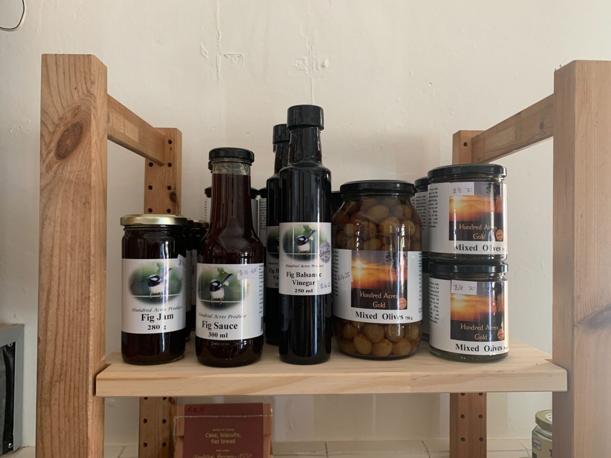 Bottles of fig products on shelf.