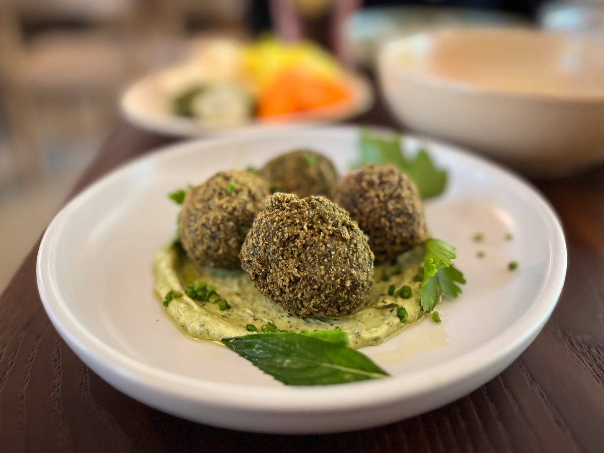 plate of green falafel with herbs