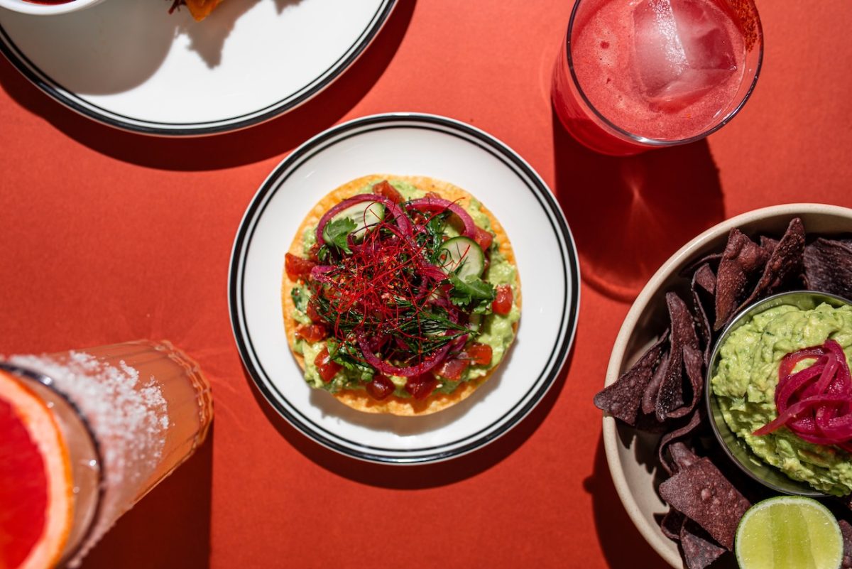 Top down image of tostada on red tablecloth