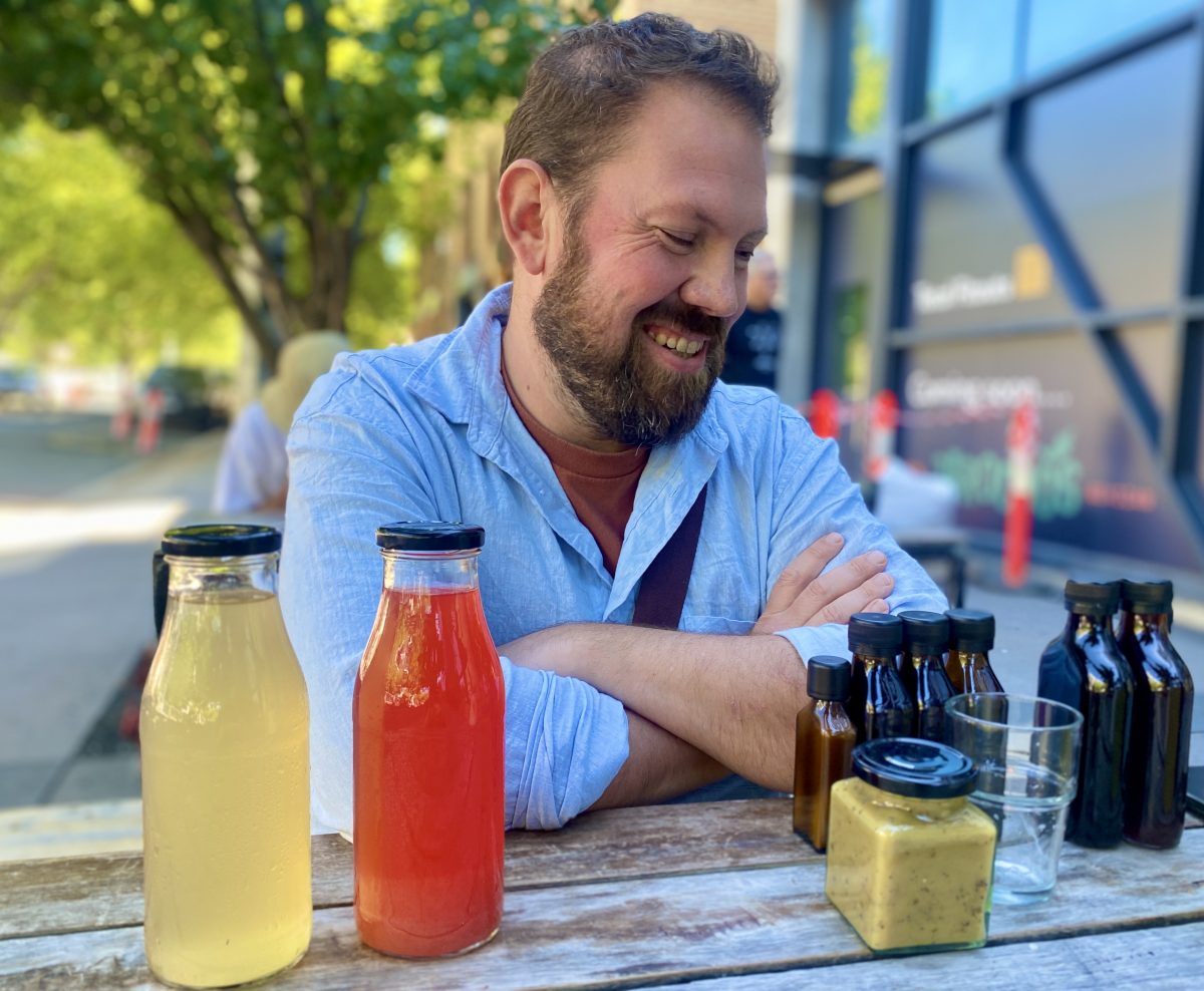 Trent Brown with samples of kombucha and hot sauces.