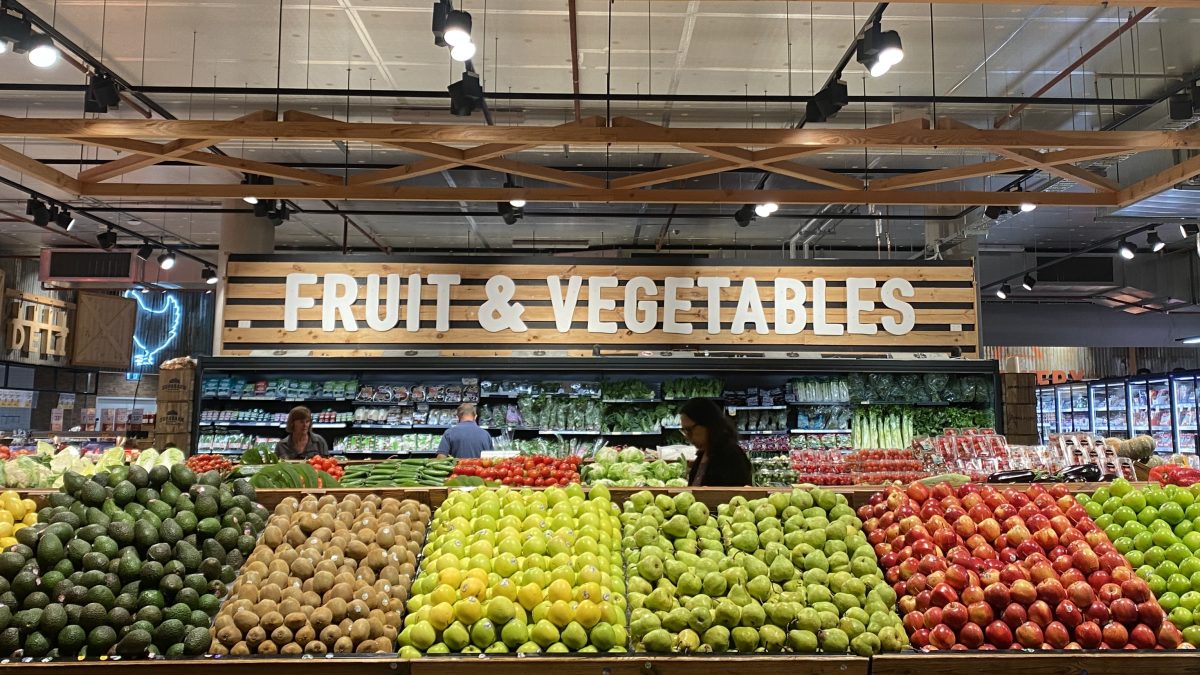Fruit and Vegetables sign at Supabarn Kingston with apples and other fruit in foreground.
