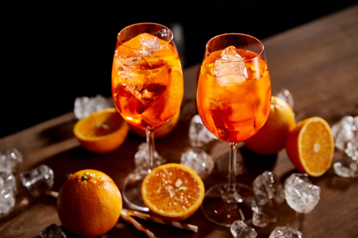 two glasses of aperol spritz with orange garnish