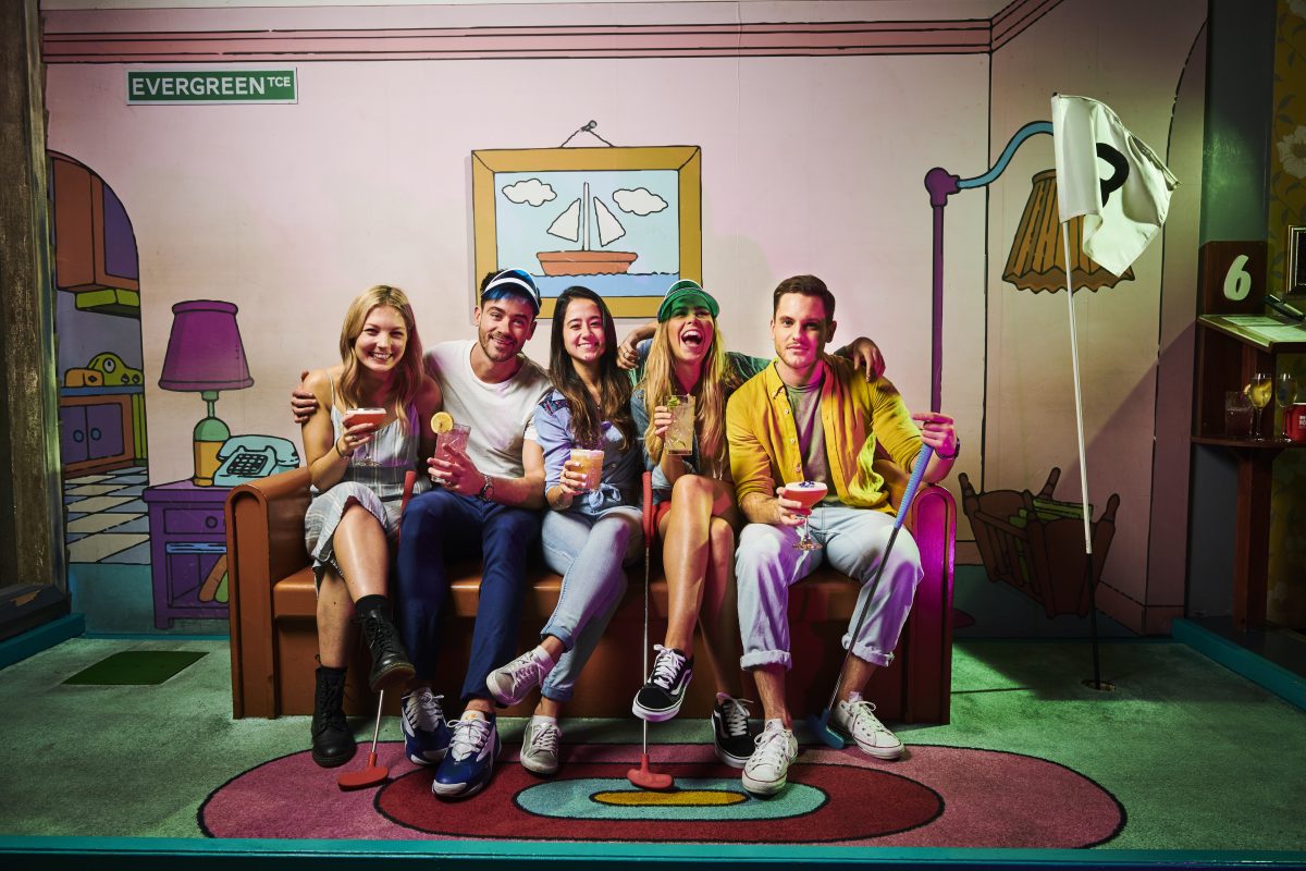 young people sitting on SImpsons couch