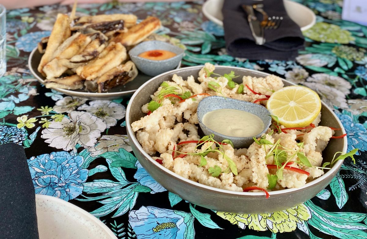 Fried squid in bowl on colourful tablecloth